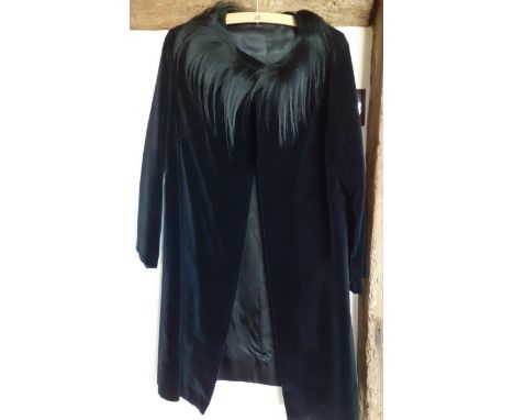 A mid 20th Century bespoke black velvet opera coat with black ostrich feather neckline and large black beaded button to the f