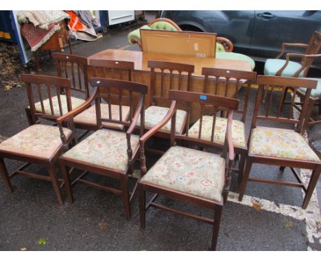 A set of eight early 19th century mahogany dining chairs with tapestry seats and on square legs, two being carvers 