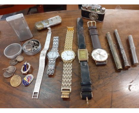 A 1930's gold plated watch on a leather strap, four other watches, vintage lighters, propelling pencils to include an engrave