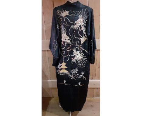 A vintage Chinese black silk kimono with images of wind dragons to the rear and outline swirls to the front in gold, silver a