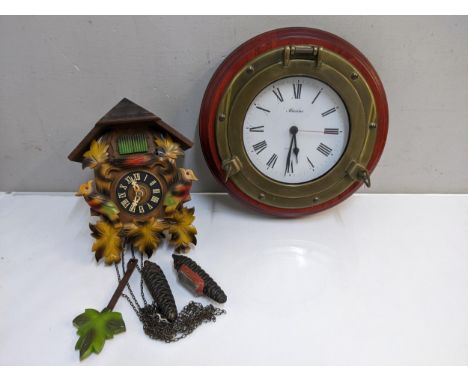 A 20th century painted, carved wooden cased cuckoo clock and a modern quartz marine clock Location: G 