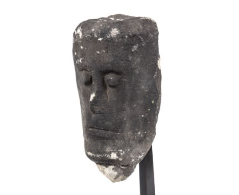 A Celtic quartzite limestone head, with a tenon below possibly a trophy head from 5th-10th century 12cm wide 21cm high