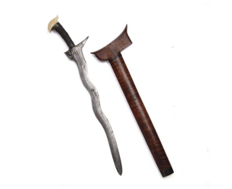 A late 19th century Indonesian kris dagger with an ivory and wire hilt, a forged-steel blade and a wooden sheath the blade 42