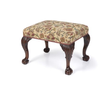 A late 18th century Chippendale style black walnut stool with an upholstered top, carved cabriole legs and claw and ball feet