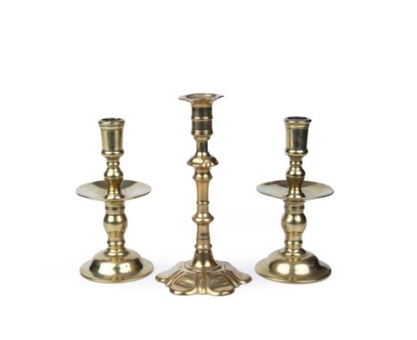 Two late 17th century Duch Heemskerk brass candlesticks, 18cm high; together with an 18th century English push-up candlestick