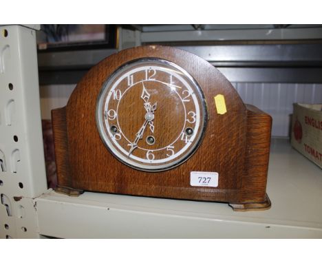 An oak cased chiming mantel clock