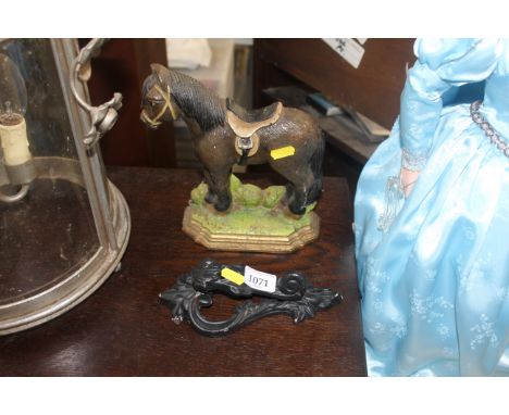 A doorstop in the form of a horse and a door knocker