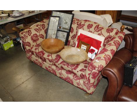 A floral upholstered two seater sofa