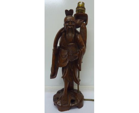 A carved oriental figural lamp base
