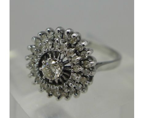 An 18ct white gold and diamond cluster ring, weight 4.8g, size M