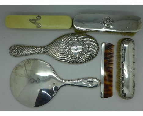 Two silver backed brushes, two silver backed mirrors, one other brush and a comb