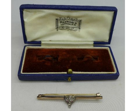 A diamond set fox head brooch with ruby eyes
