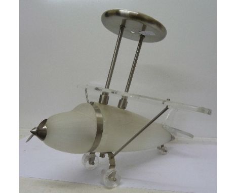 A modern ceiling light in the form of an aeroplane, the plane with frosted glass body and perspex wings