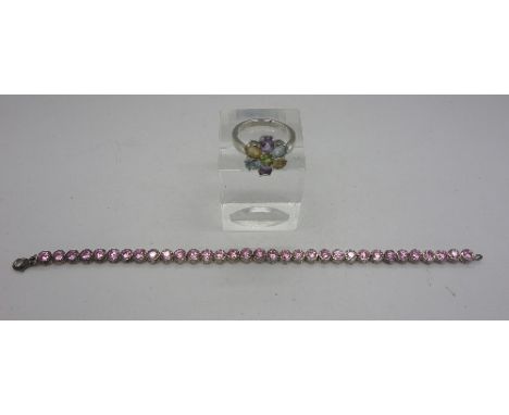 A silver and pink stone tennis bracelet and a silver ring