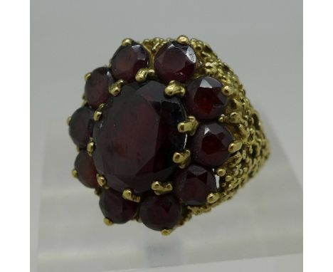 A large 9ct gold and garnet cluster ring, weight 7.7g, size L