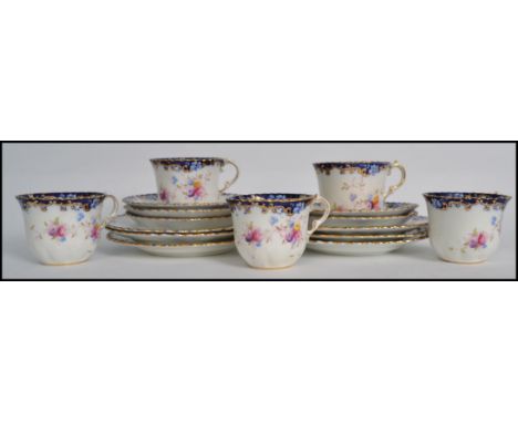 A good group of five early 20th century Royal Albert Crown china trios in an Imari / chintzy pattern consisting of cups, sauc