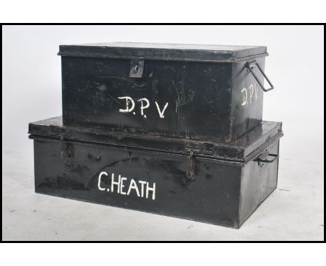 Two vintage 20th century retro industrial ebonised steamer trunks having bold white lettering to lid that open to reveal a sp