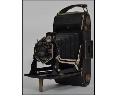 A vintage mid 20th century Zeiss Ikon bellows camera complete in it's original leather case.