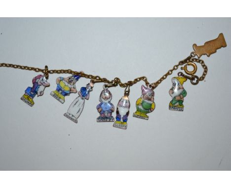 A stunning vintage charm bracelet featuring eight enamel charms modelled on Walt Disney's Snow White anfdthe Seven Dwarfs