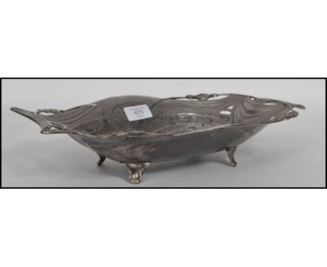 A vintage Art Nouveau pewter dish having pieced rose handles with scalloped edge in the manner of WMF.