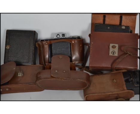 A collection of vintage cameras to include Century bellows camera being mahogany and black canvas bound, a vintage Butchers C