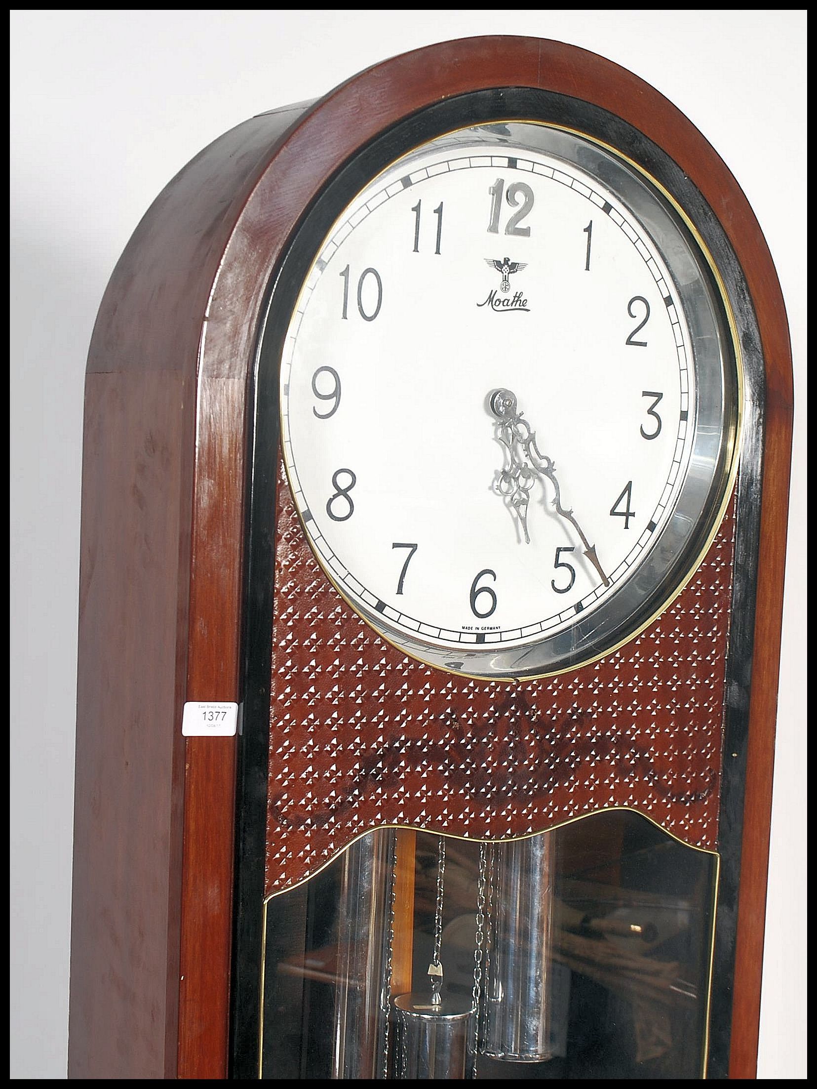 A 20th century large German free standing grandfather clock by Moathe / Mauthe raised on a large