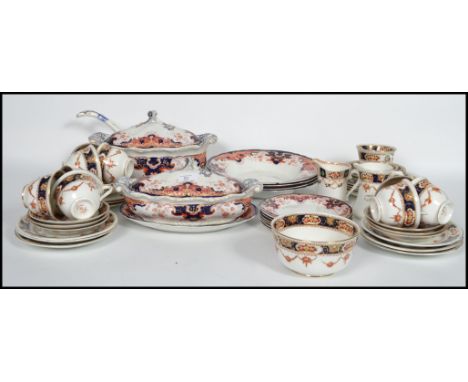 An Imari pattern 19th century part dinner service to include tureens and dinner plates etc together with a Royal Albert Imari