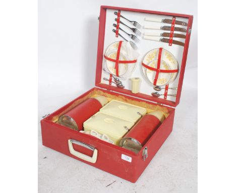 A vintage 1960's / 1970's retro picnic hamper by Revelation. The case with red vinyl outer being fully appointed with ceramic
