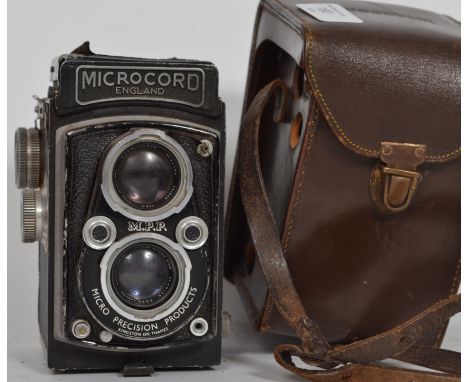 A  vintage MPP Micro Precision Products Microcord twin lens reflex camera in a brown leather case, the lenses marked for ROSS