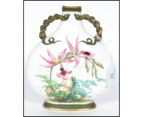 A 19th century Minton moon flask vase hand painted with flora on a white ground with naturalistic gilt handles to the tapered