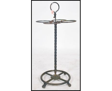 A unusual early 20th century vintage metal stick / umbrella stand having a central twist column with four hooped sections and