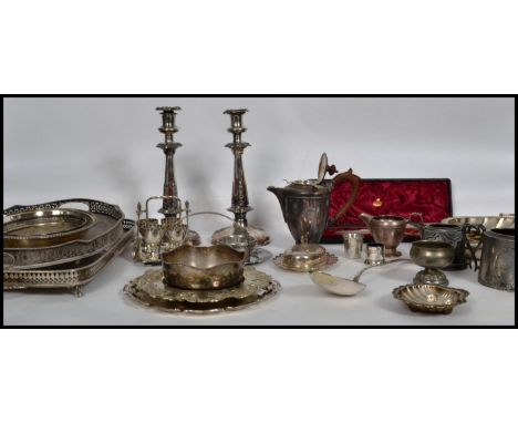 A large collection of silver plated wares to include a pair of large candlesticks, a 4 person egg coddler set with stand, par