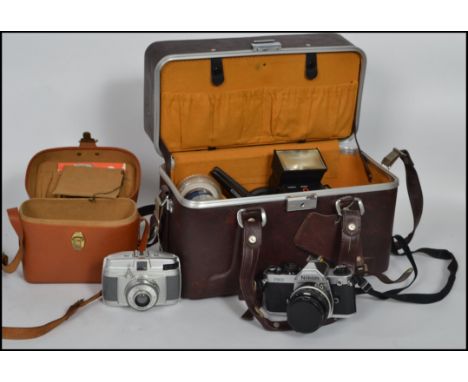 A  vintage Nikon FM2 camera and accessories to include camera bag, 50mm f1.8 lens, 24mm f2.5mm lens, lens hood, small tripod,