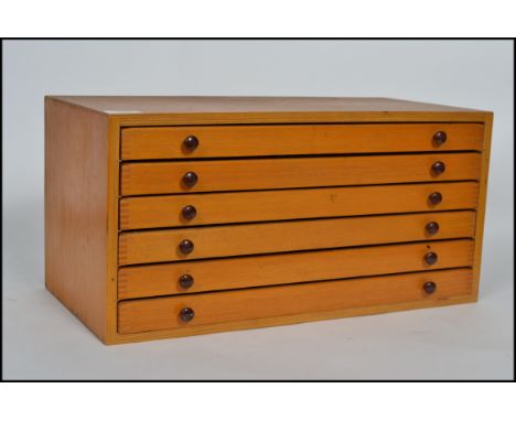 A vintage 20th century pine specimen / tools cabinet having multiple pull out drawers with handles.