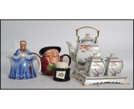 A collection of teapots to include examples such as  Franklin Mint Ltd edition teapot with creamer and stand, Tony Woods etc.