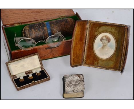 A mixed lot of various antiques to include a silver hallmarked cherub prayer book, cased spectacles, cased portrait miniature