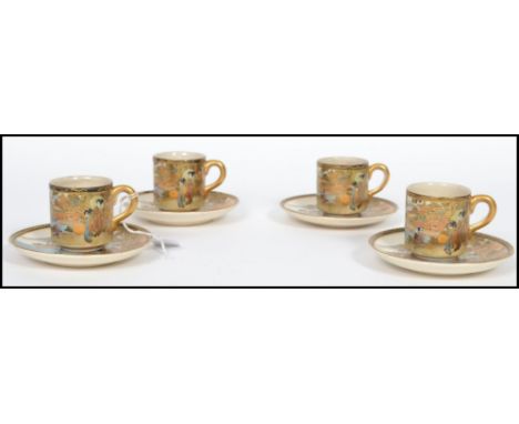 A matching set of four 19th century Oriental Meiji period Japanese Satsuma coffee cups / cans and saucers being hand painted 