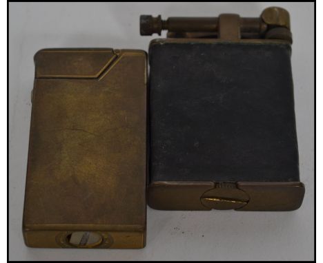 A fabulous mid 20th century Dunhill petrol lighter together with another lighter of similar age. Measures 6cms high.