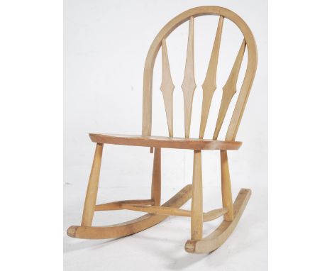 A vintage mid century Ercol beech and elm rocking chair - armchair designed by Lucian Ercolani. Sleigh runners with turned le