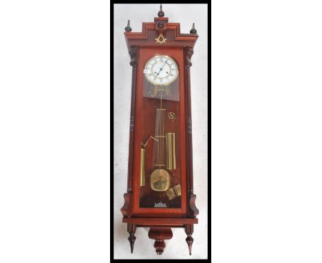 A Franz Hermle large Vienna style wall clock model 241-840 with Masonic symbol to front, three finials to top and two to bott