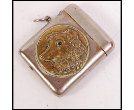 A vintage silver white metal vesta case having a circular gilt medallion with working dog with glass eye and notation for Sco