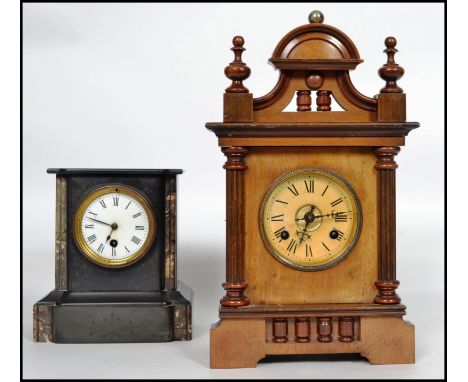 A late 19th century marble and slate mantel clock together with an eight day mantel clock set within a wooden case. Measures 