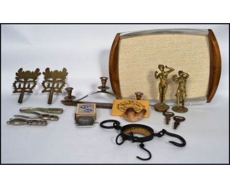 A collection of vintage brass items to include bottle openers in the form of naked females, scales, GWR cap badge, Georges ad