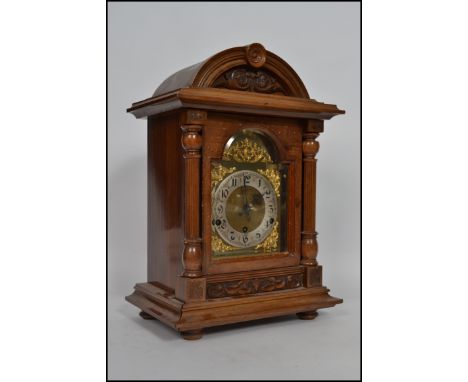 A 19th-century walnut mantel clock having a dome top raised on columns, the clock has a 3 train movement with a gilt brass fa
