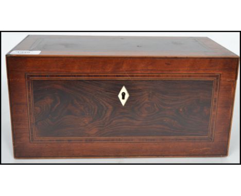 A 19th century Georgian mahogany and coromander twin barrel tea caddy being cross banded with rosewood with hinged lid openin