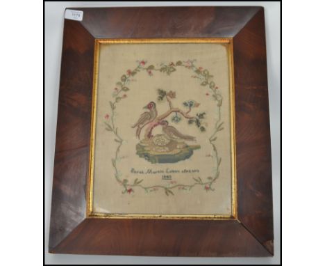 A 19th century Victorian period framed and glazed needlepoint tapestry sampler depicting nesting birds and tending for thier 