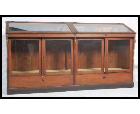 An impressive 20th century large Italian shop / museum display cabinet.  Of large form with mirror lined glass hinged top ove