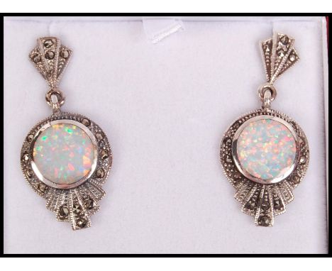 A pair of Art Deco style silver, marcasite and opal adorned ladies earrings complete in the presentation case. 