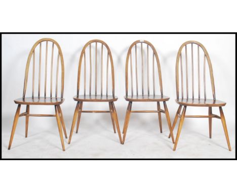 A set of four Ercol Golden Dawn coloured beech and elm framed Windsor, high hoop, spindled back dining chairs with solid seat