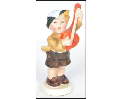 A rare believed unlisted 20th century Goebbels Hummel ceramic figurine of a boy playing a mandolin having a mark 2 Bee stamp 